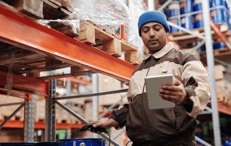 Amazon's fulfillment alternatives: worker scanning product in a warehouse