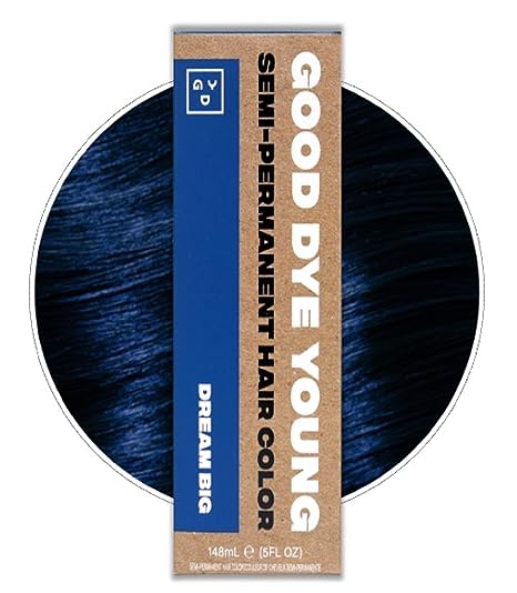 An image of a box of Good Dye Young brand hair dye. The box is brown with a dark blue rectangle. Behind the box is an image of a swatch of hair that has been dyed blue. The label on the box reads "Good Dye Young Semi-Permanent Hair Color" and the color of the dye is listed as "Dream Big."