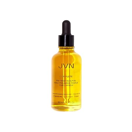 An image of a bottle of JVN scalp oil. The bottle is clear and the oil inside is a rich gold color. The bottle has a black eyedropper cap.